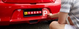 LTrent-student-putting-VIC-P-plate-on-car-crop.jpg