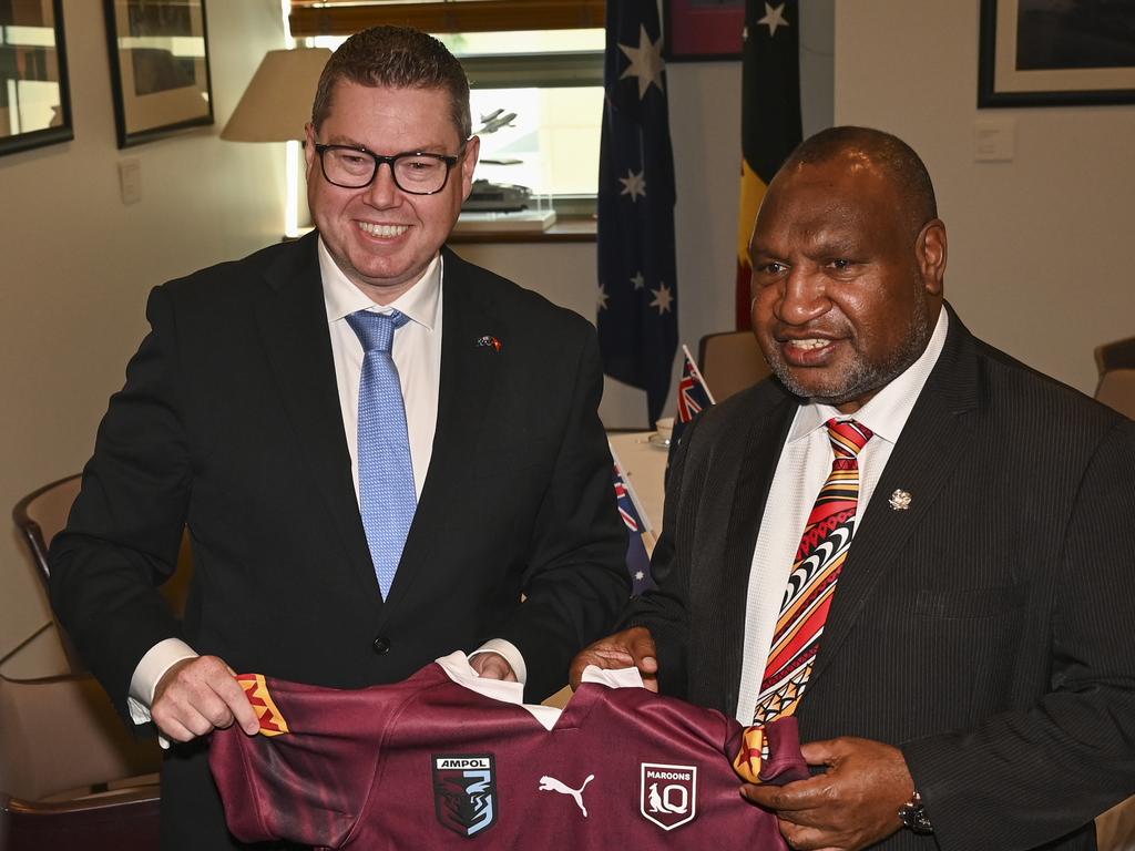 The Minister for International Development and the Pacific, Pat Conroy presents the Prime Minister of Papua New Guinea with a signed rugby league jersey. Picture: Martin Ollma